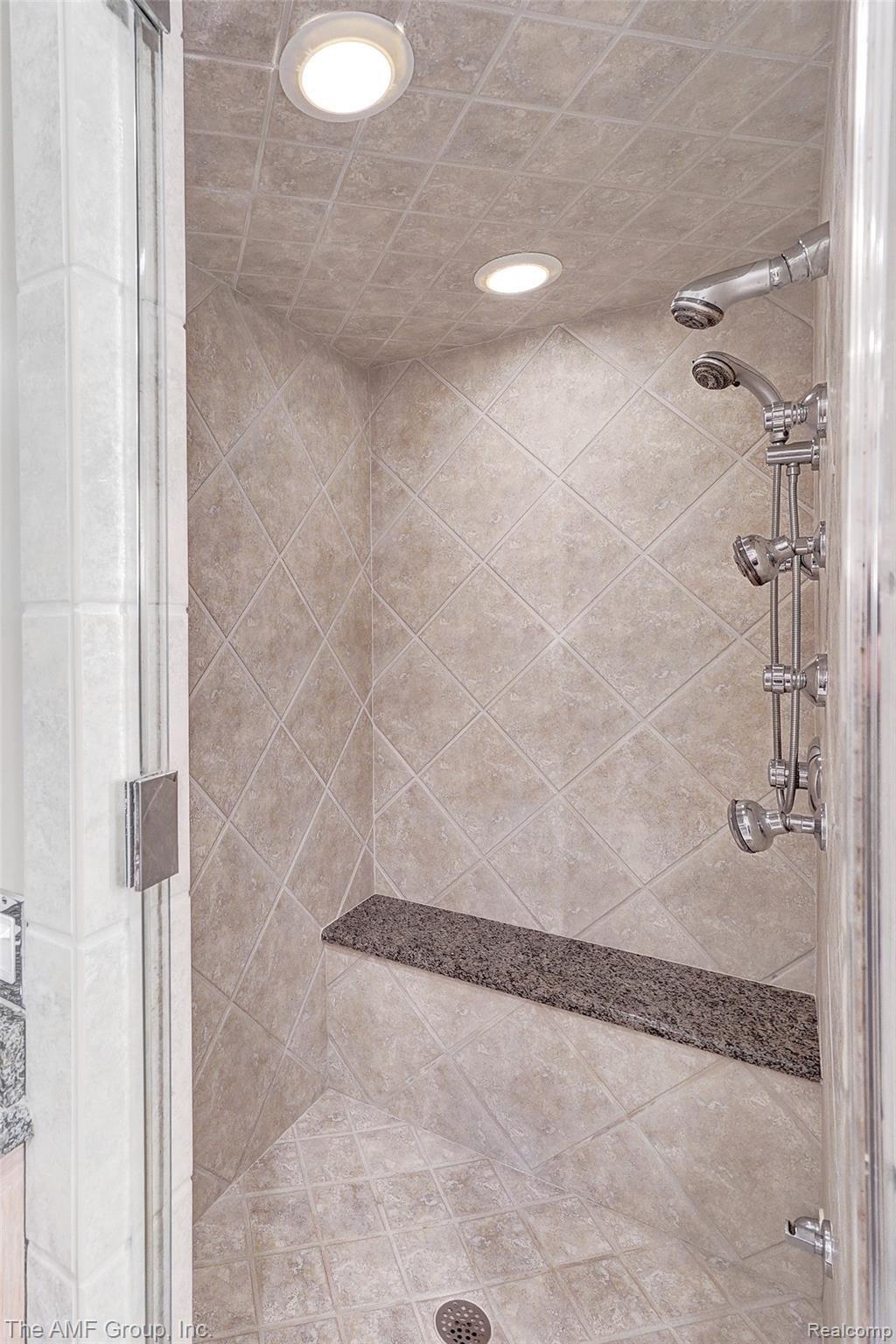 2695 Dutton Road Rochester, MI 48306 - Photo 14 of 41 Master bath shower with multiple heads and a bench.