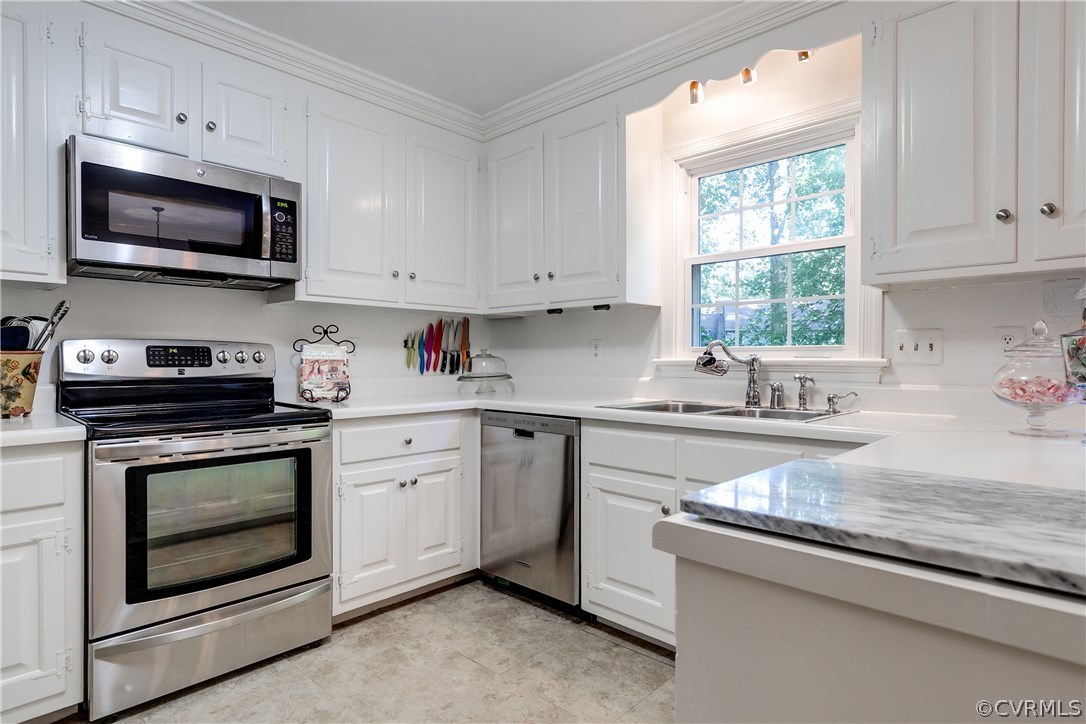 13507 Queensgate Road Midlothian, VA 23114 - Photo 11 of 45 a kitchen with granite countertop white cabinets appliances a sink and a window