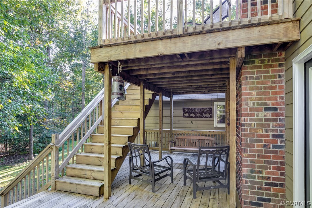 13507 Queensgate Road Midlothian, VA 23114 - Photo 41 of 45 a view of a patio with table and chairs with wooden floor and fence and a floor to ceiling window