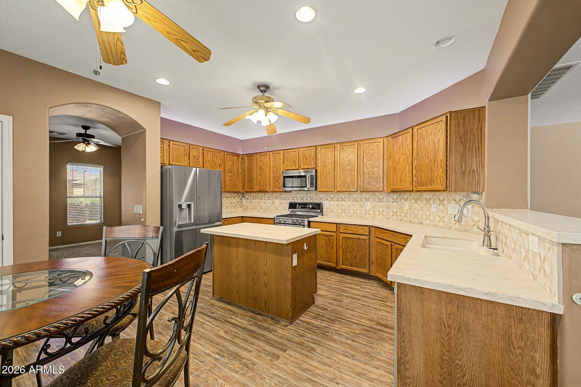 6622 West Harwell Road Laveen, AZ 85339 - Photo 10 of 32 a kitchen with stainless steel appliances granite countertop a sink a stove and a refrigerator