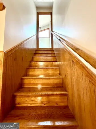 a view of a room with wooden floor and windows