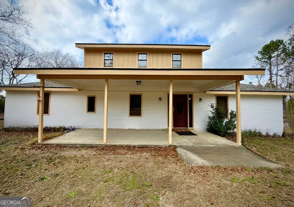 a view of a house with wooden fence
