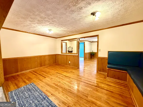 a living room with furniture and a kitchen