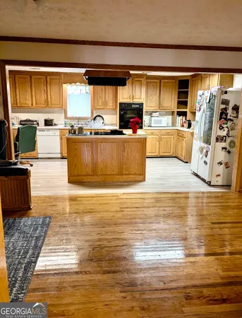 a view of a room with wooden floor and gym equipment