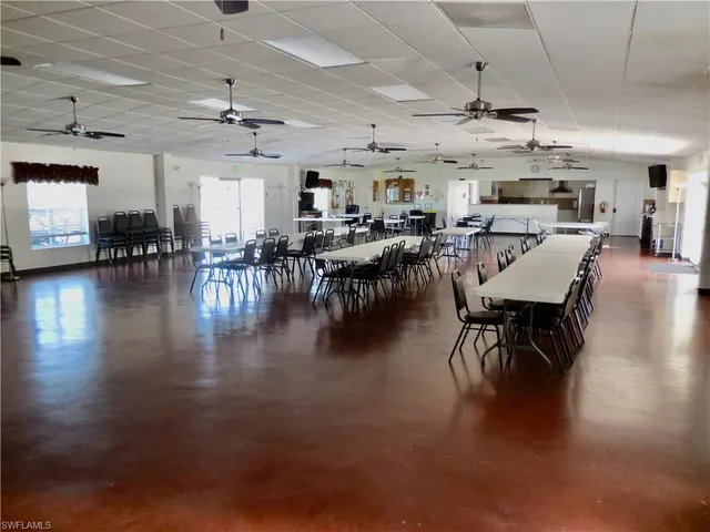a view of a dining room with furniture chandelier and wooden floor