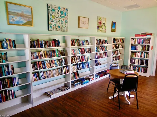 a view of a workspace with bookshelf and a book shelf
