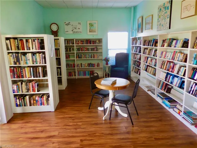 a view of a livingroom with furniture and bookshelf