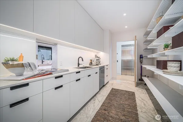 a kitchen with stainless steel appliances granite countertop a sink and cabinets