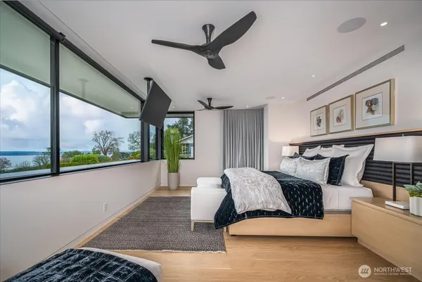 a bedroom with a large bed and a large window