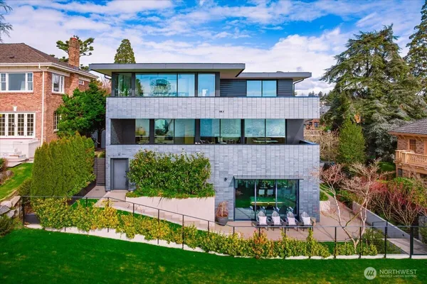 a view of a brick house with a yard and plants