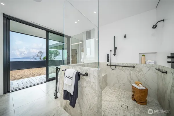 a bathroom with a tub a sink double vanity and a mirror