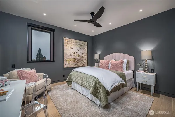 a bedroom with furniture and a wooden floor