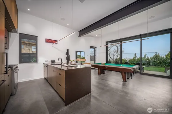a living room with furniture pool table and flat screen tv