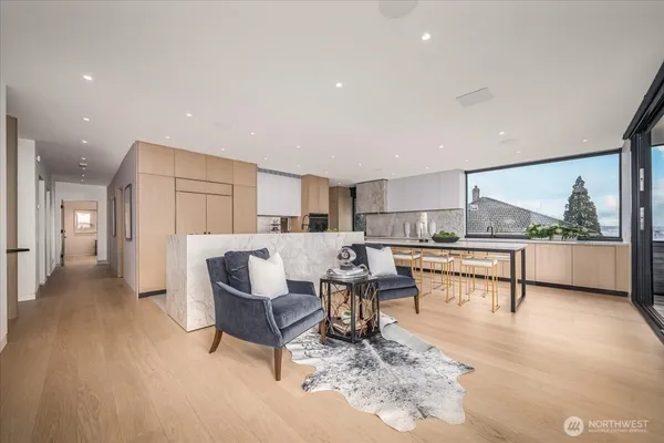 a kitchen with kitchen island granite countertop a large window and a counter space
