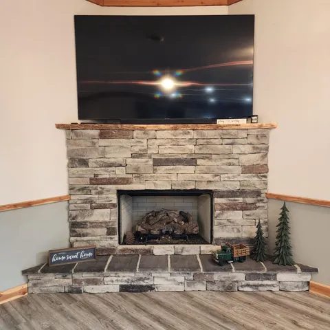 a room with fireplace and a wooden floor