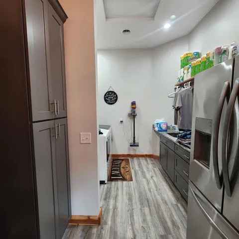 a kitchen with a refrigerator and a stove