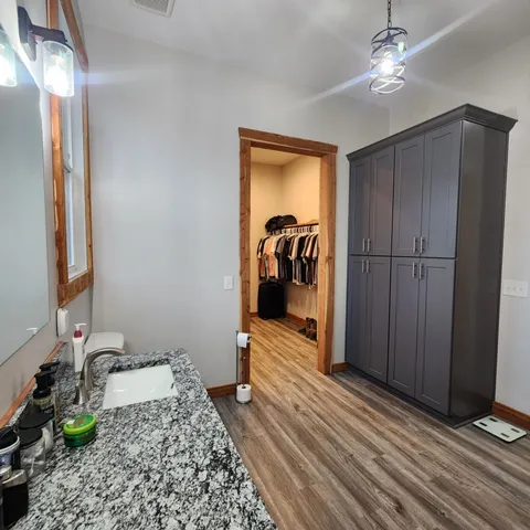 a kitchen with sink stove and cabinets