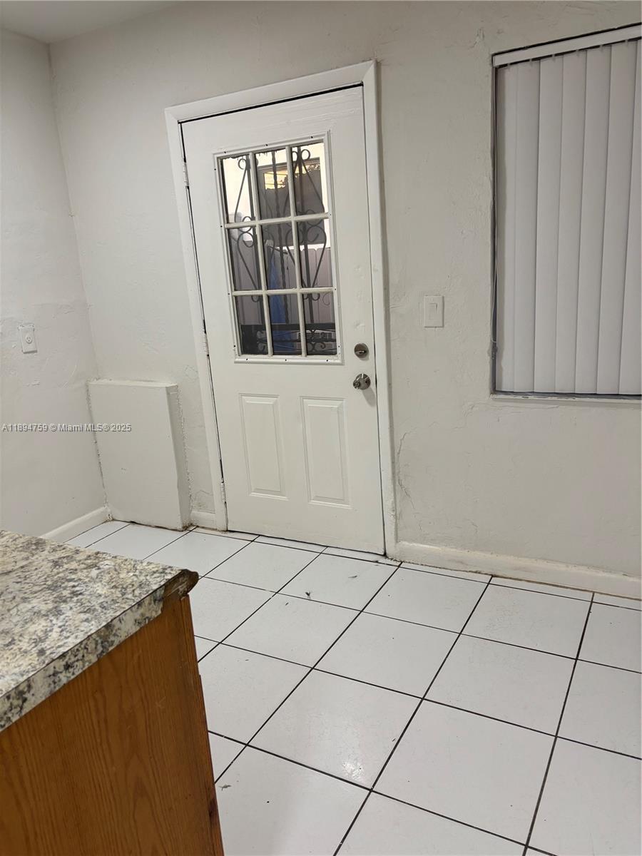 2070 Washington Avenue, Unit 2 Opa-Locka, FL 33054 - Photo 3 of 6 a view of an empty room with windows