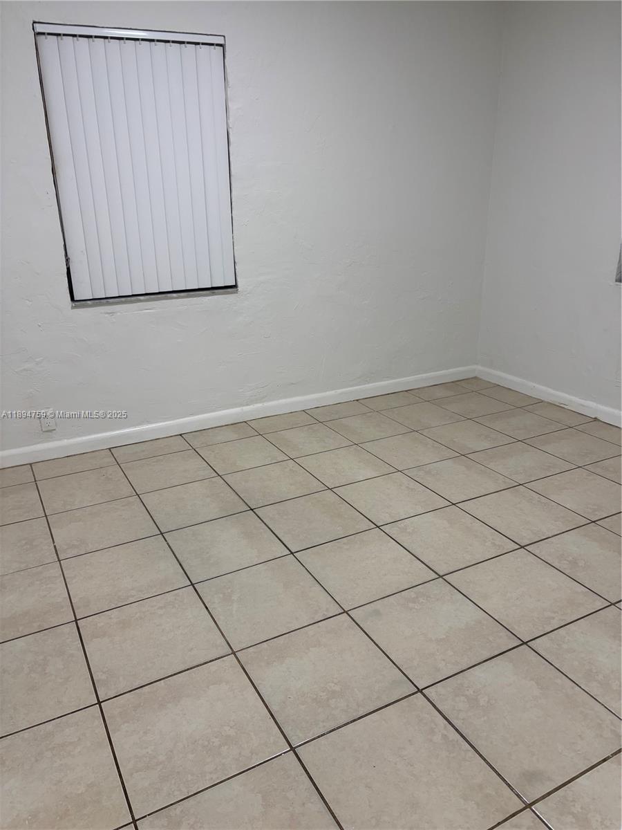 2070 Washington Avenue, Unit 2 Opa-Locka, FL 33054 - Photo 5 of 6 a view of a room and window