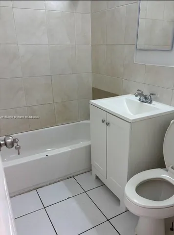 a bathroom with a sink a toilet and bathtub