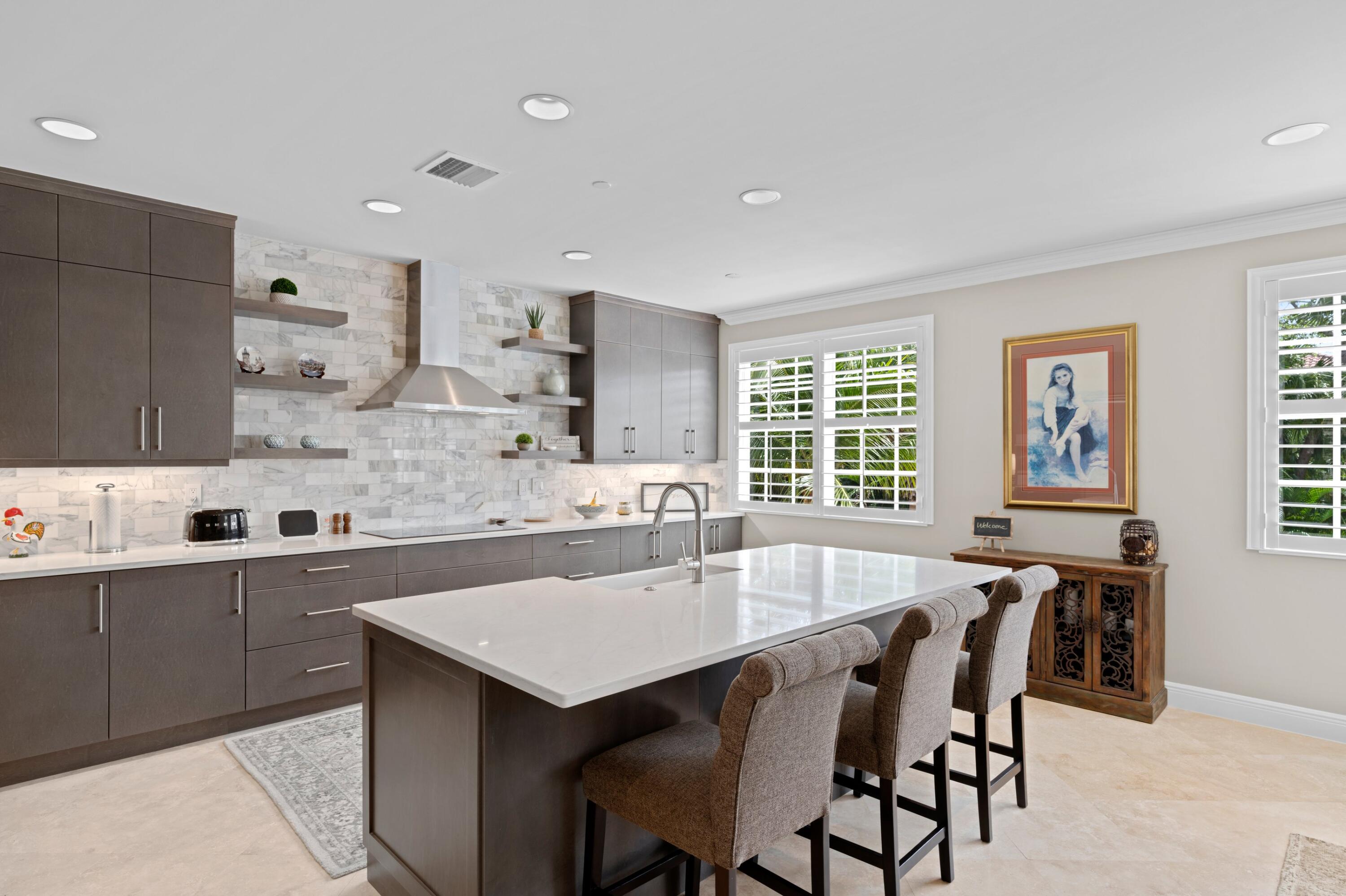 648 Northeast Francesca Lane Boca Raton, FL 33487 - Photo 1 of 40 a kitchen with stainless steel appliances a table and chairs in it
