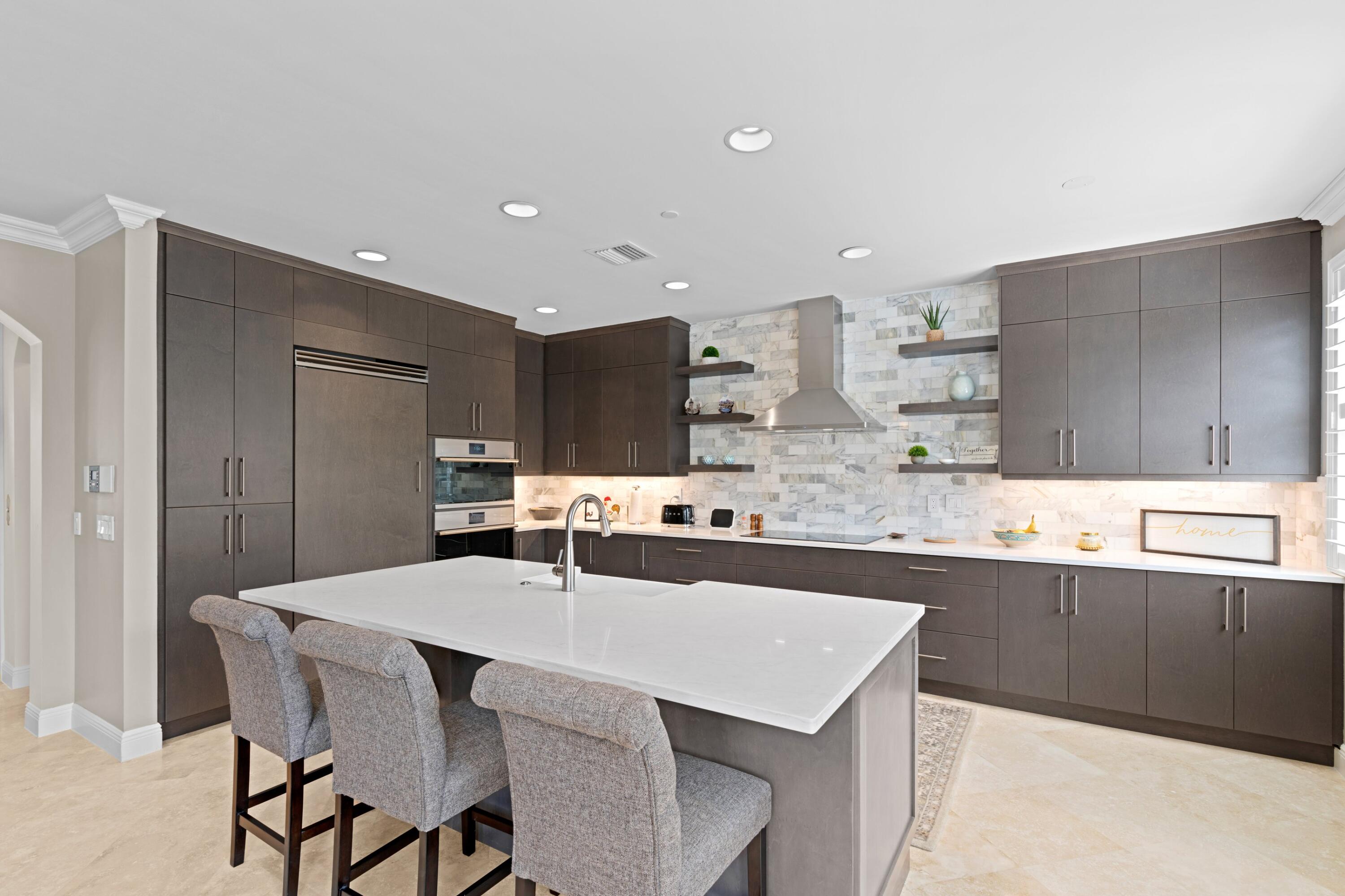 648 Northeast Francesca Lane Boca Raton, FL 33487 - Photo 16 of 40 a kitchen with center island and stainless steel appliances