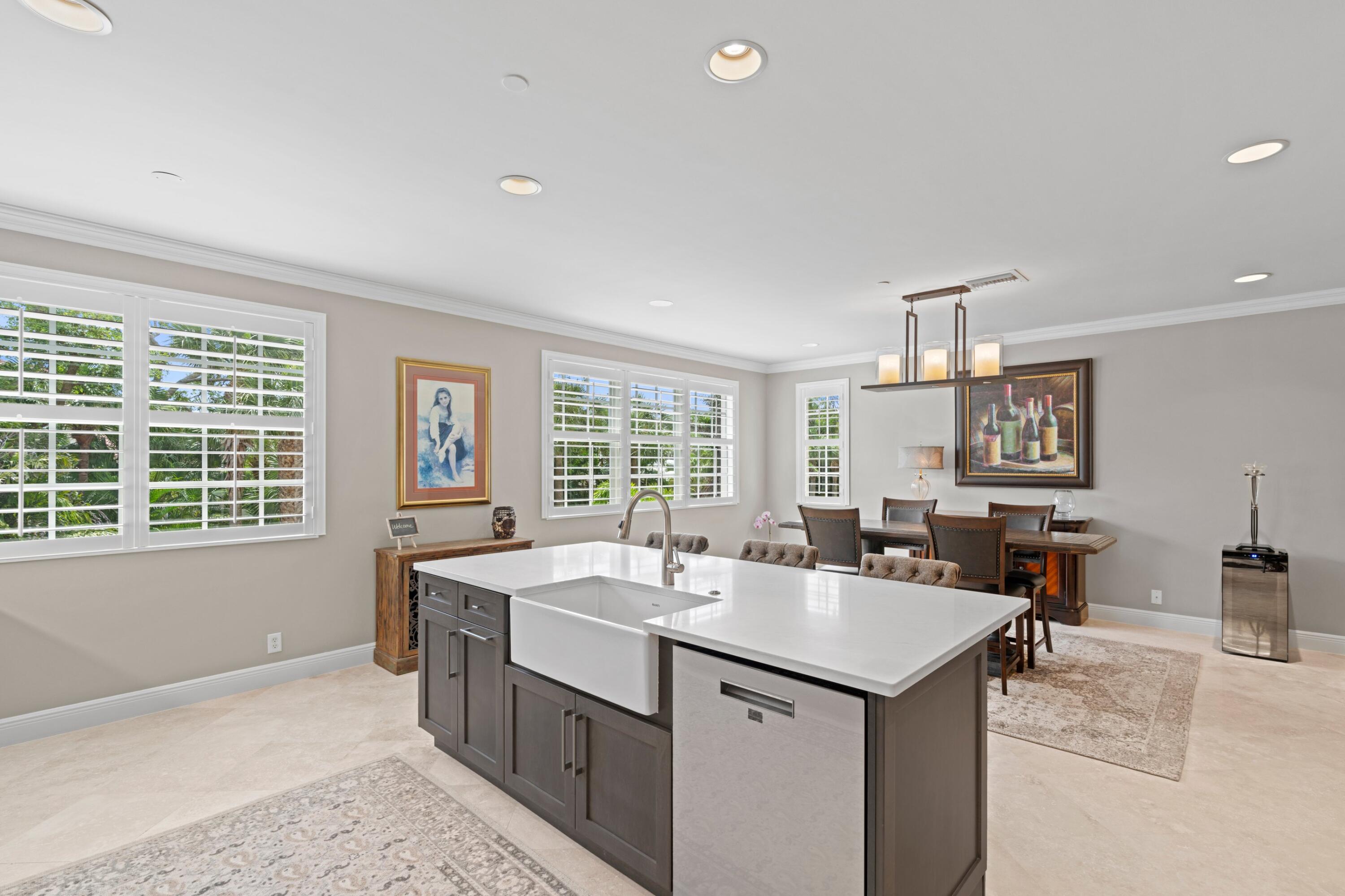 648 Northeast Francesca Lane Boca Raton, FL 33487 - Photo 20 of 40 a view of center kitchen island a sink a table and chairs
