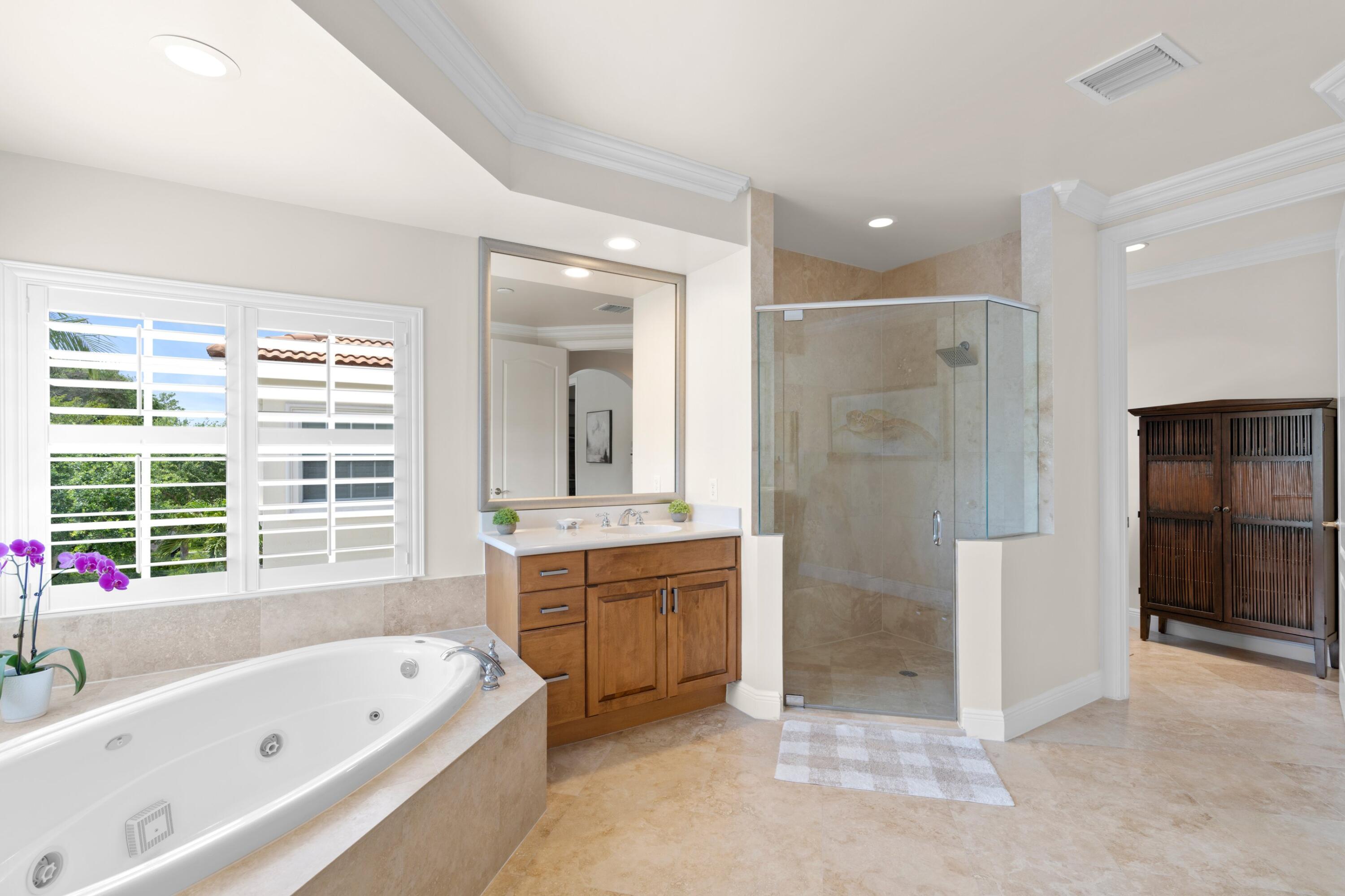 648 Northeast Francesca Lane Boca Raton, FL 33487 - Photo 26 of 40 a bathroom with a tub a sink shower and a mirror