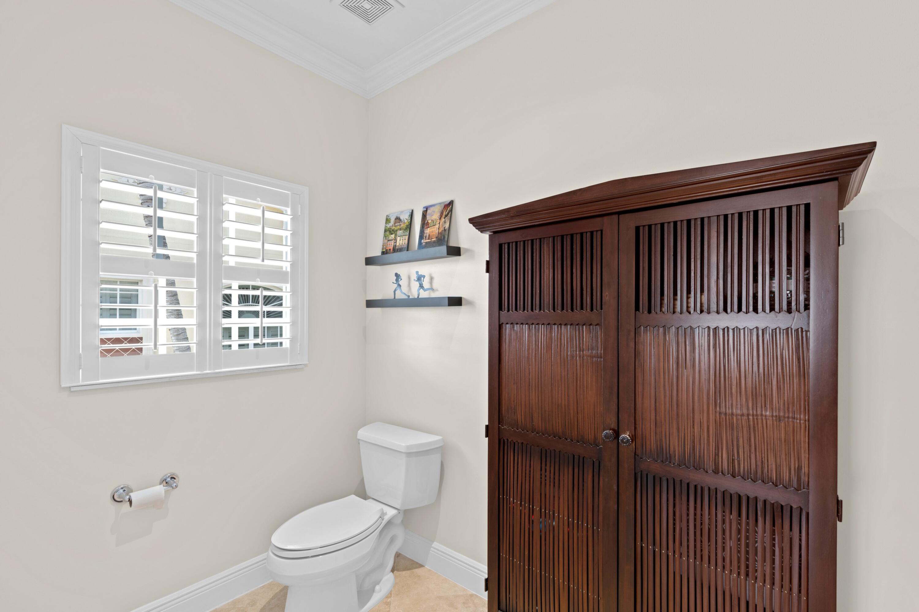 648 Northeast Francesca Lane Boca Raton, FL 33487 - Photo 27 of 40 a bathroom with a toilet and a shower curtain