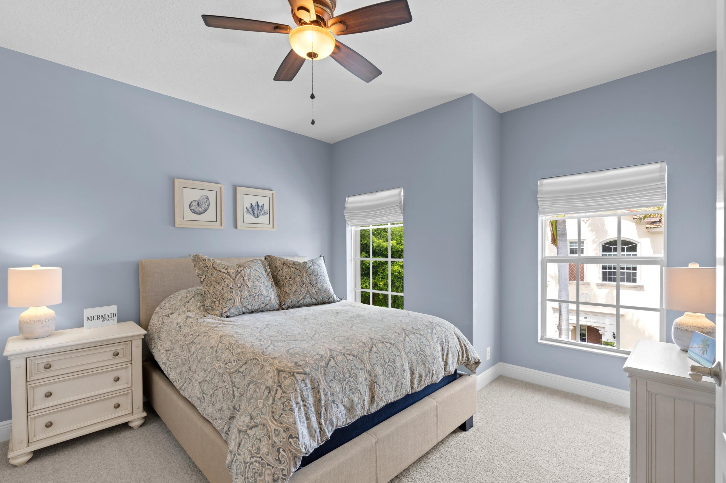 648 Northeast Francesca Lane Boca Raton, FL 33487 - Photo 28 of 40 a bedroom with a large bed and a chandelier