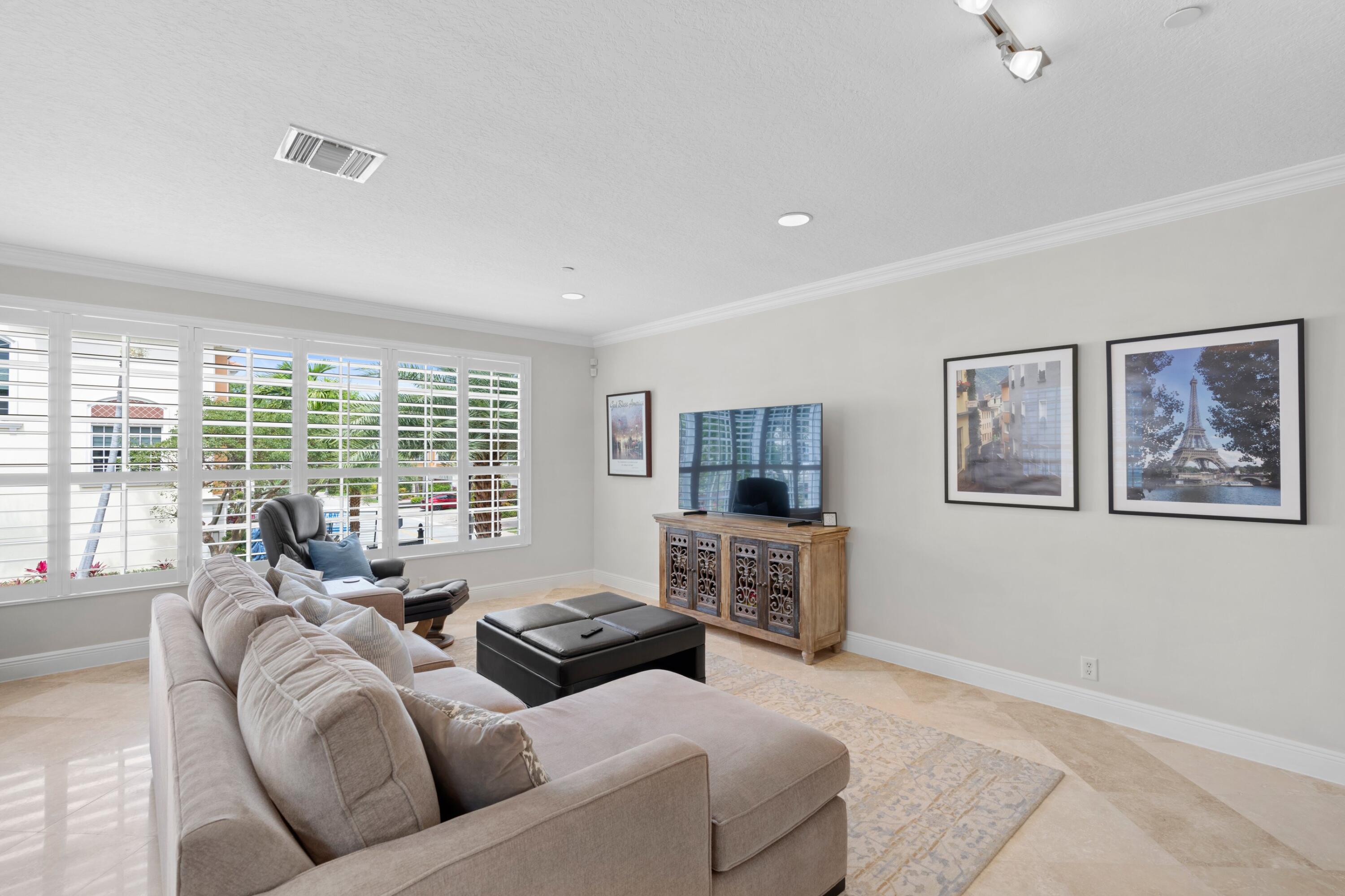648 Northeast Francesca Lane Boca Raton, FL 33487 - Photo 10 of 40 a living room with furniture large window and flat screen tv