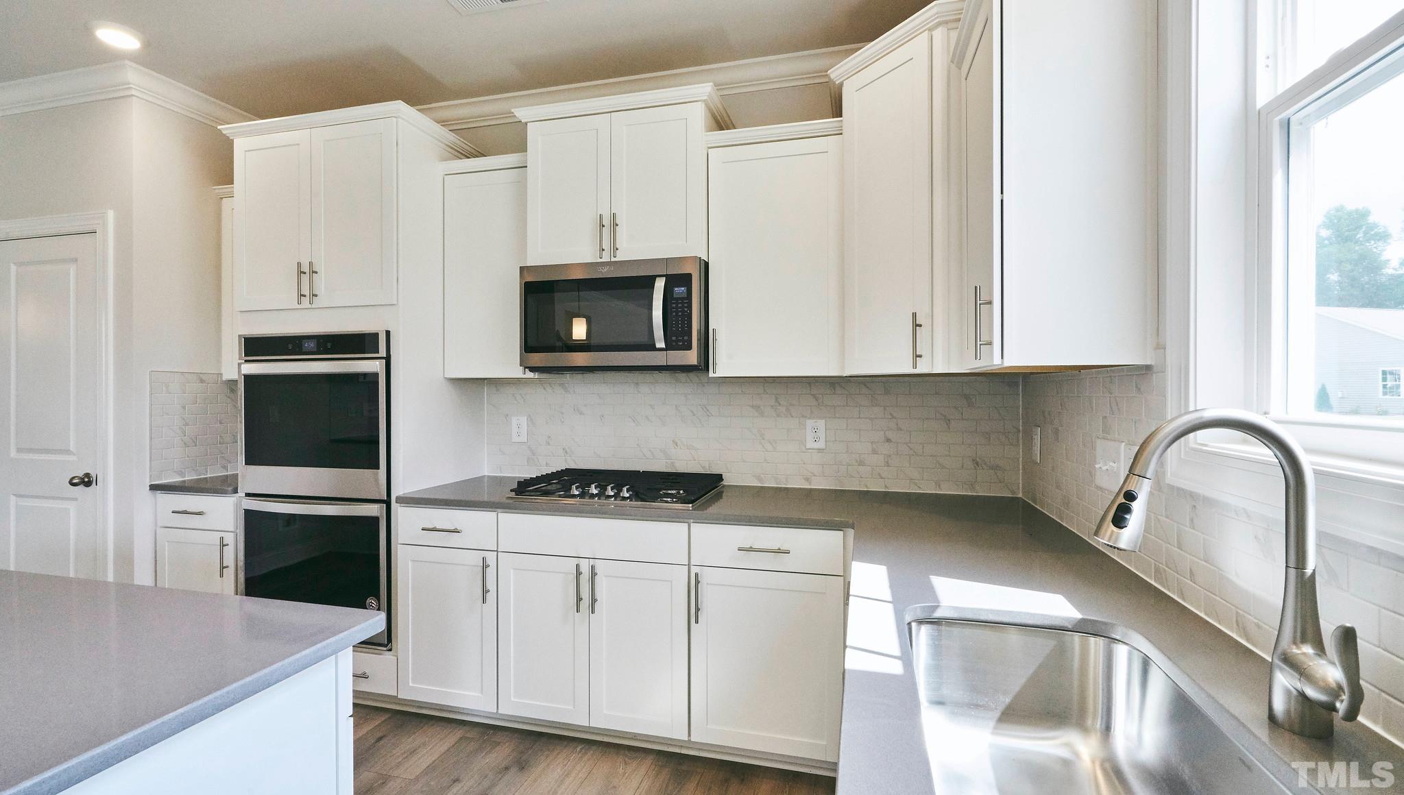 4200 Cross Timber Lane Raleigh, NC 27603 - Photo 2 of 34 -layout is of different plan; photo shown to represent designer kitchen inclusions and interior color package included in home
