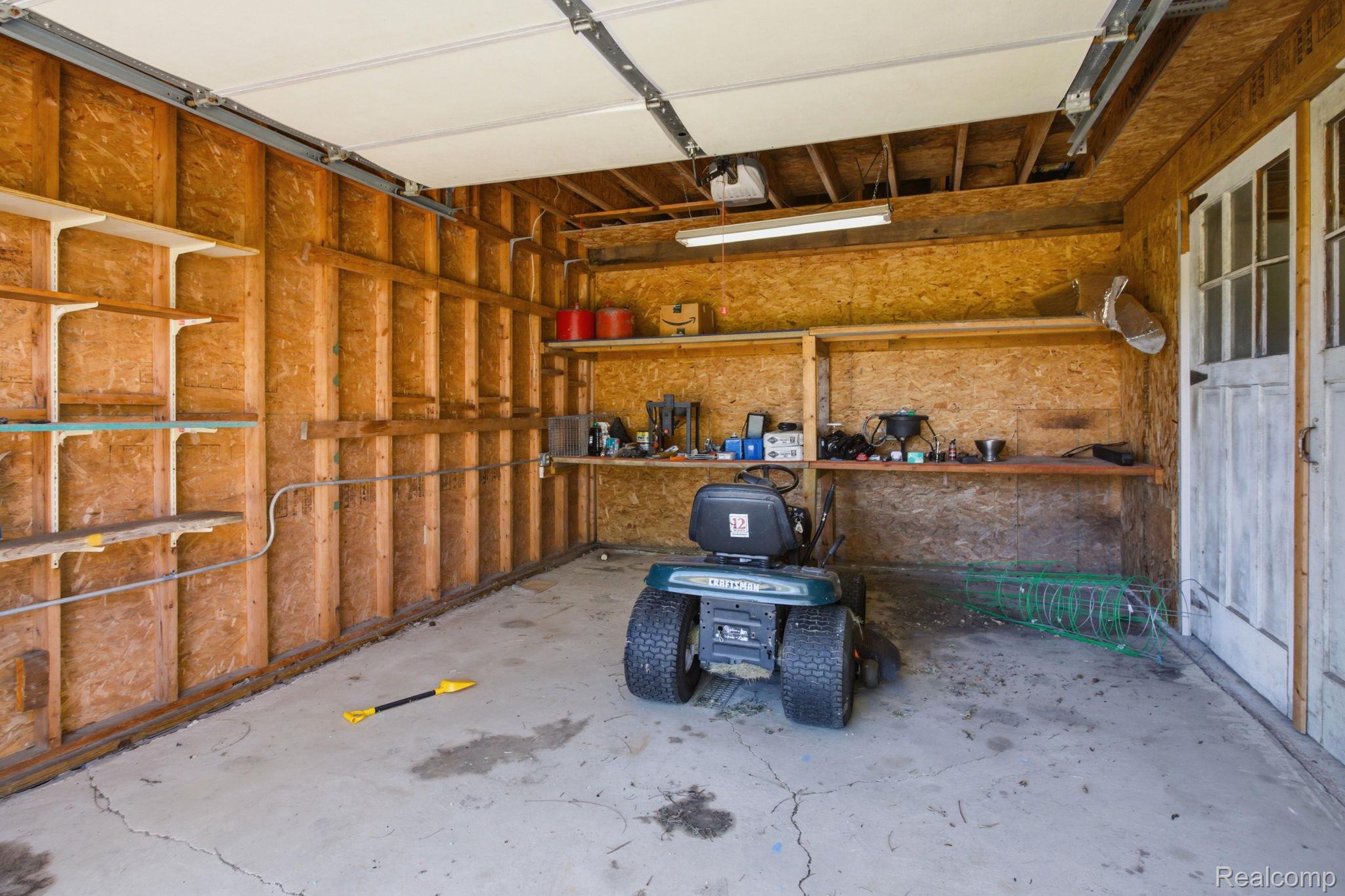 14104 Carleton West Road Carleton, MI 48117 - Photo 51 of 58 Garage featuring a garage door opener