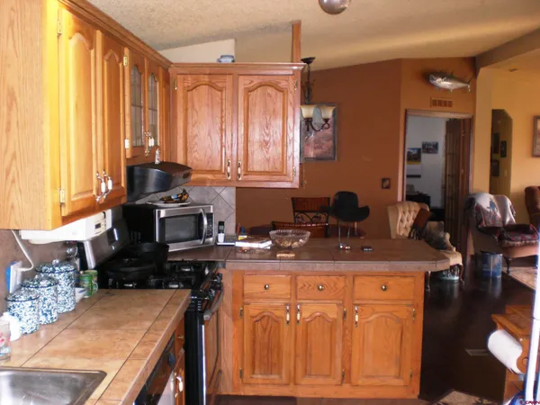 a kitchen with a table chairs and a window