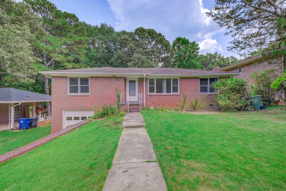 4598 Bakers Ferry Road Southwest Atlanta, GA 30331 - Photo 1 of 1 a front view of house with yard and green space