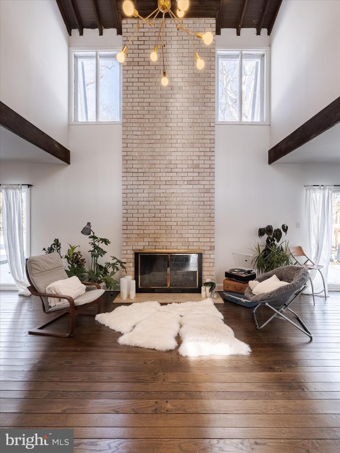 919 Laburnum Lane Wyncote, PA 19095 - Photo 2 of 43 a living room with furniture wooden floor and a fireplace