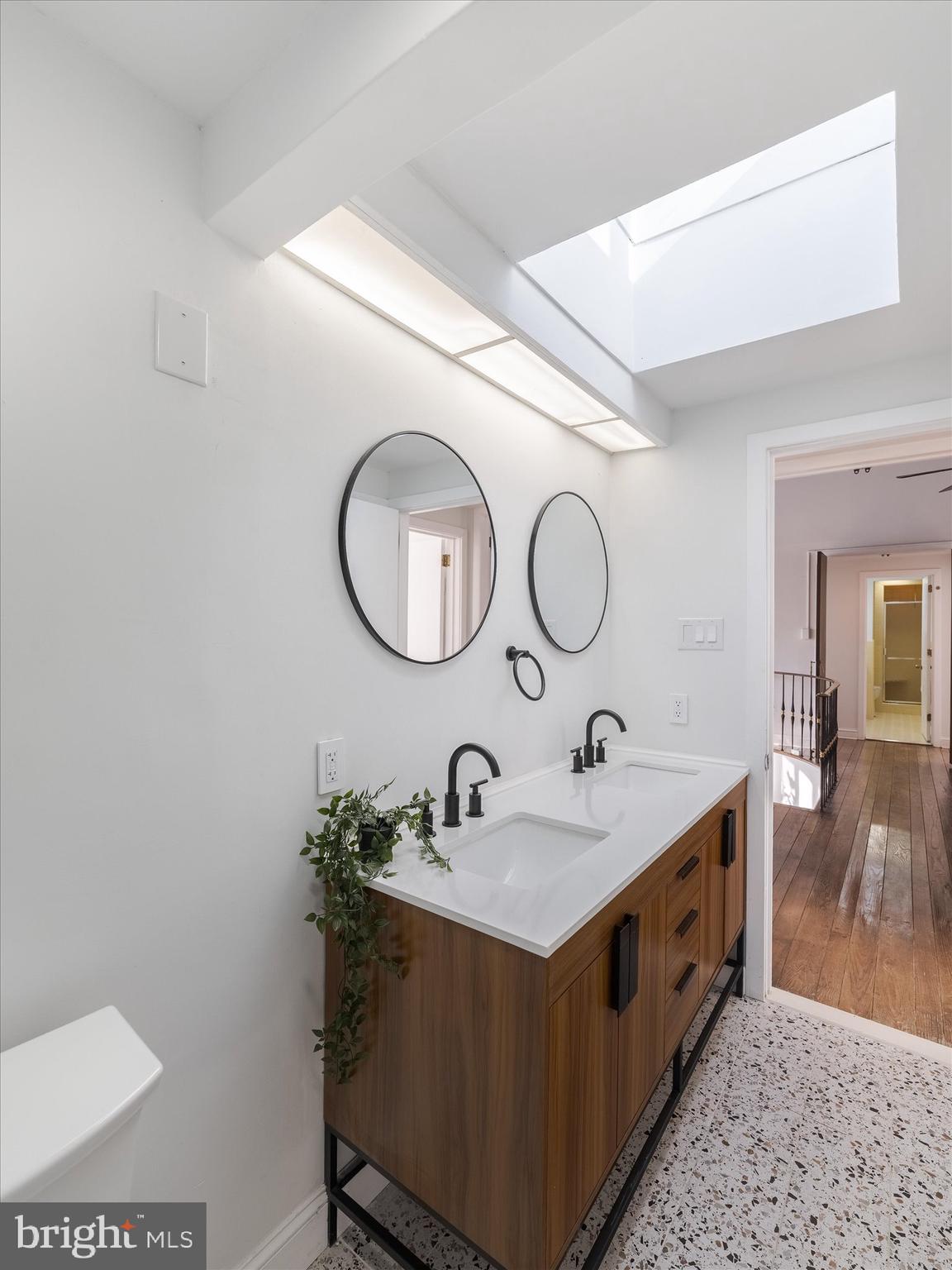 919 Laburnum Lane Wyncote, PA 19095 - Photo 10 of 43 a bathroom with a double vanity sink and a mirror
