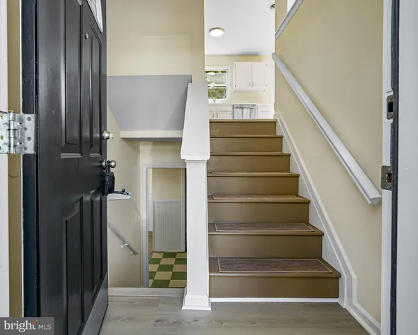 a view of entryway and hall with wooden floor