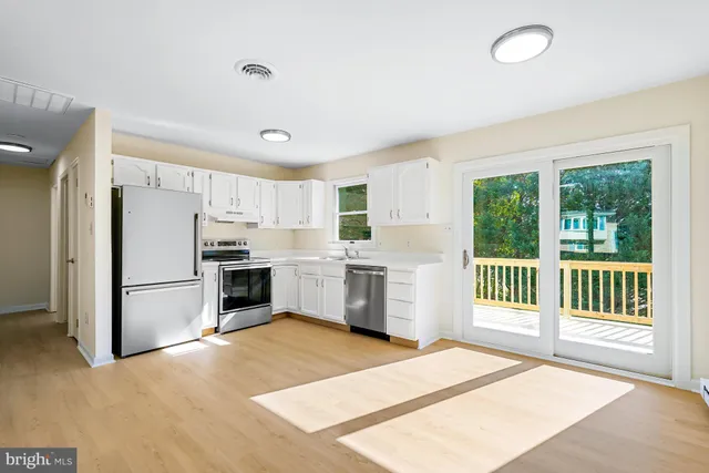 a kitchen with a refrigerator and a sink