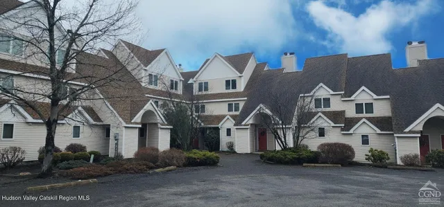 a front view of residential houses and yard