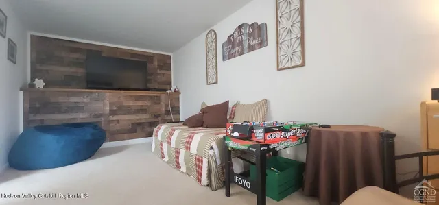 a bedroom with furniture and a flat screen tv