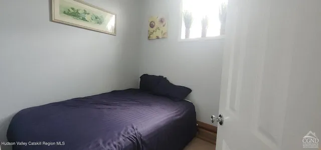 a bed sitting in a bedroom next to a window