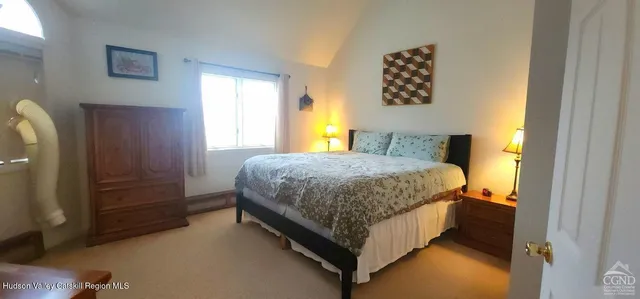 a bedroom with a bed and window