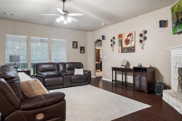 a living room with furniture a large window and a table
