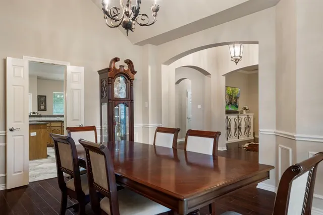 a living room with furniture wooden floor and a table