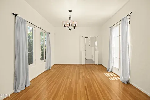 a view of a room with wooden floor and windows