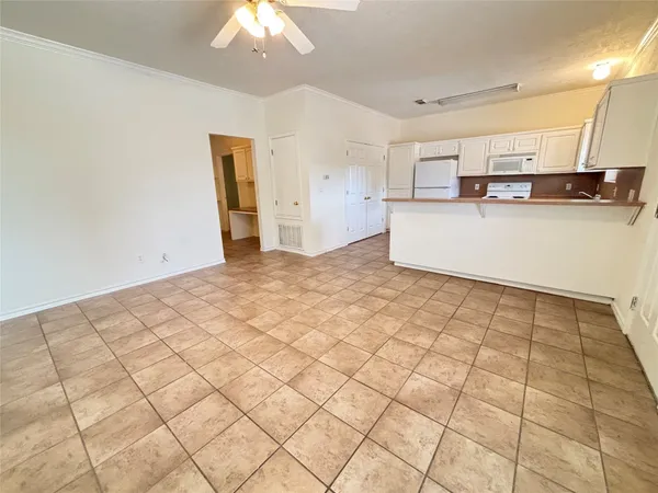 a view of a kitchen with microwave and cabinets