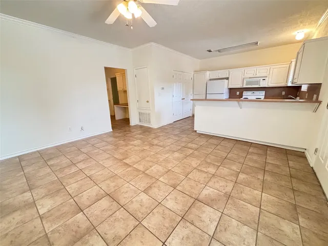 a view of a kitchen with microwave and cabinets