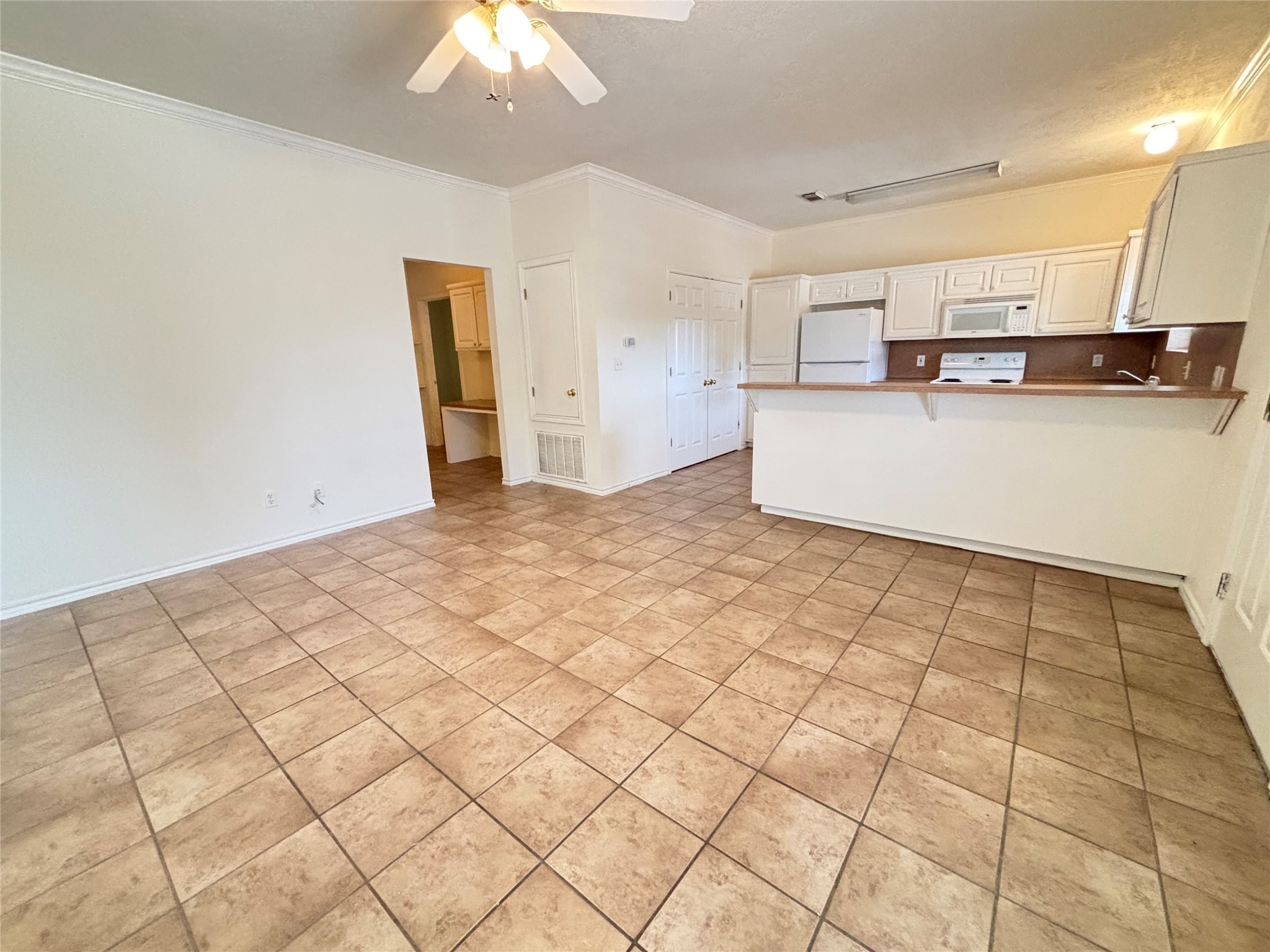 a view of a kitchen with microwave and cabinets