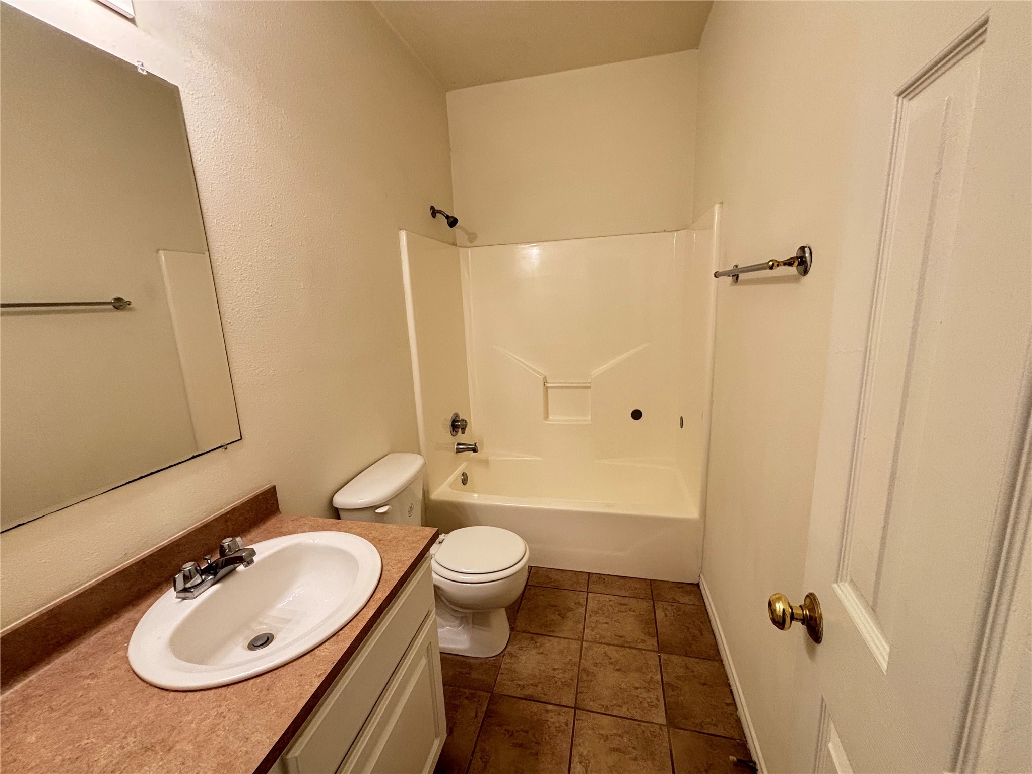 2455 Montgomery Road Huntsville, TX 77340 - Photo 7 of 10 a bathroom with a sink a toilet a mirror and shower